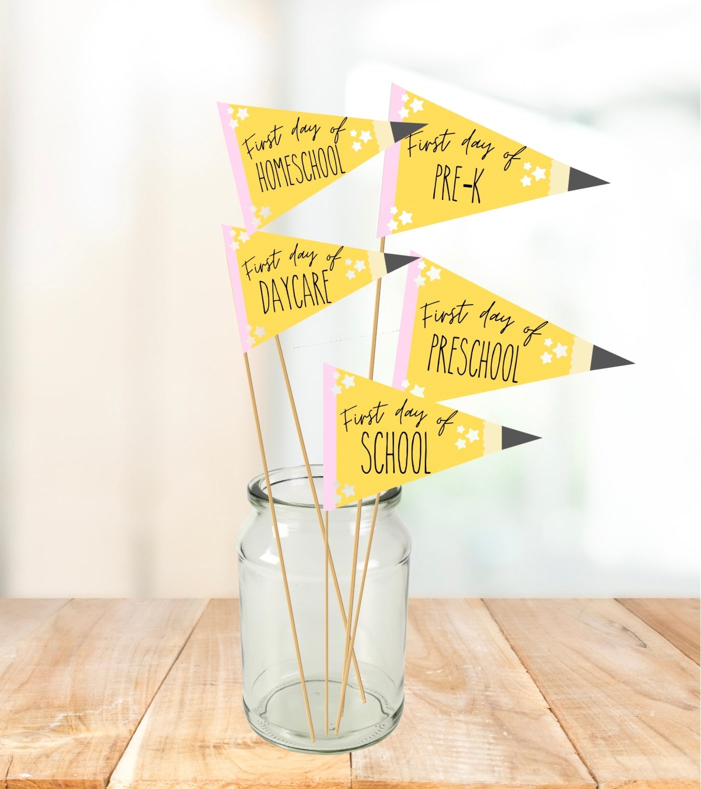First day of school printable pencil pennant signs in a glass jar — includes daycare, homeschool, pre-k, preschool, and school flags