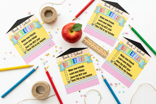 Back 2 School Bucket List gift tags flat lay with colored pencils, twine, apple, ruler, and star confetti on white surface