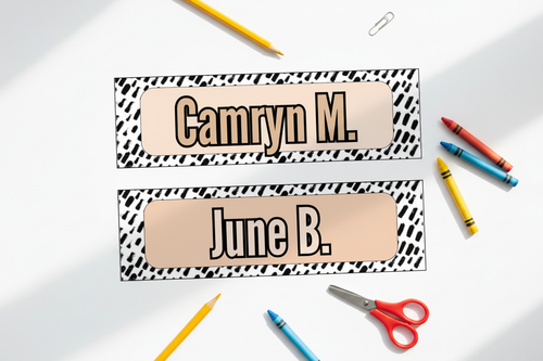 Flat lay of printed name tags with school supplies on white background